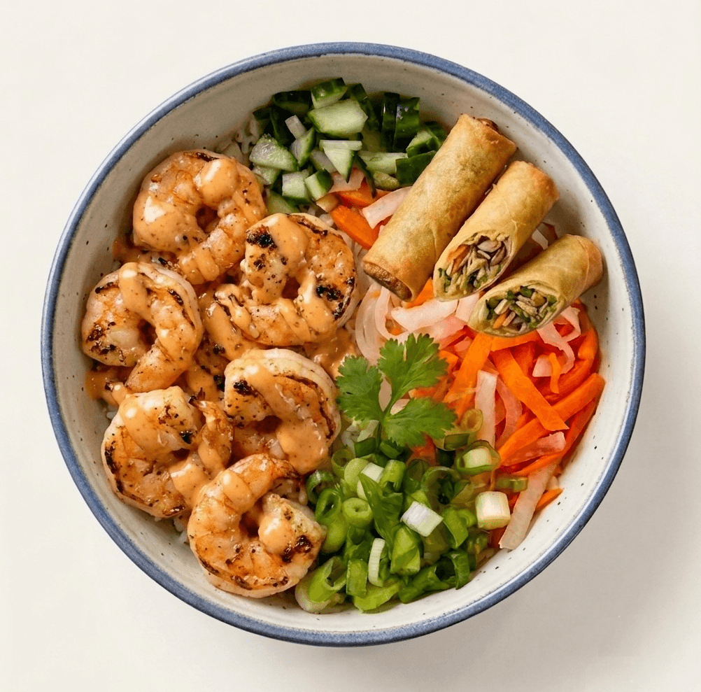 Bol de crevettes avec riz, salade et rouleaux de printemps